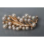 A CULTURED PEARL AND DIAMOND SPRAY BROOCH, the twenty three graduating pearls peg set to twigs on