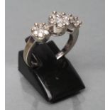 A DIAMOND TRIPLE CLUSTER RING, the central seven stone cluster point set and flanked by a pair of