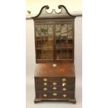 A GEORGIAN MAHOGANY BUREAU BOOKCASE, second half of the 18th century, the scrolled and pierced