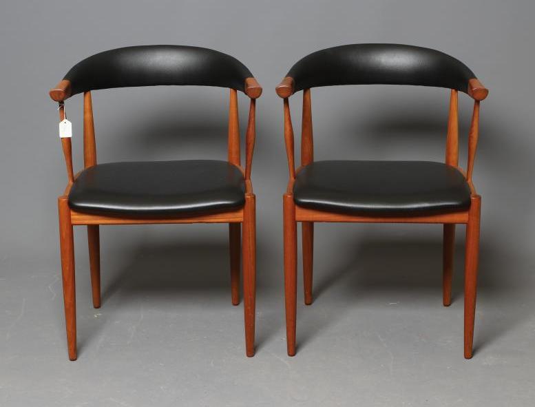 A PAIR OF TEAK ELBOW CHAIRS, mid 20th century, the open padded cow horn back and seat in black