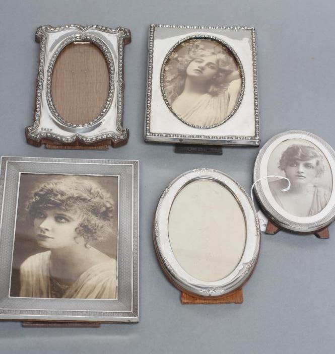 A COLLECTION OF FIVE EASEL BACK PHOTOGRAPH FRAMES, comprising two oval, Chester 1919, 6 1/4" high,