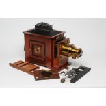 AN "OPTIMUS" MAGIC LANTERN by Perken, Son & Co. Ltd., London, in brass mounted mahogany casing,