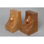 A PAIR OF ROBERT THOMPSON ADZED OAK BOOK ENDS of dished oblong form with carved mouse trademark in