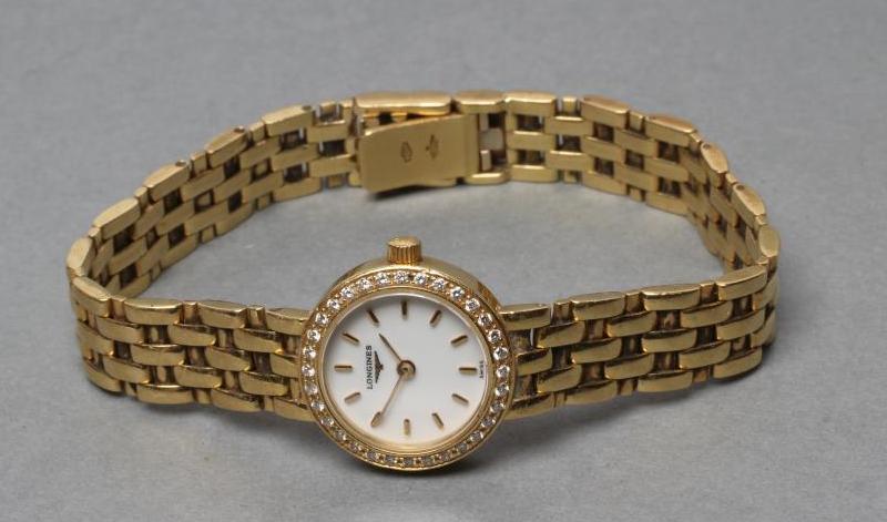 A LADY'S LONGINES 18CT GOLD AND DIAMOND WRISTWATCH, the white dial with gilt batons, the quartz five - Image 2 of 4