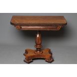 A GEORGE IV ROSEWOOD FOLDING TEA TABLE, the rounded oblong swivel top with beaded edging, panelled