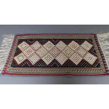 A FLAT WEAVE KILIM RUG, the navy blue field with a large trellis patterned ivory gul, within a