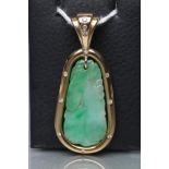 A JADE PENDANT, the tear shaped panel carved with stylised fruit pierced to hang from a