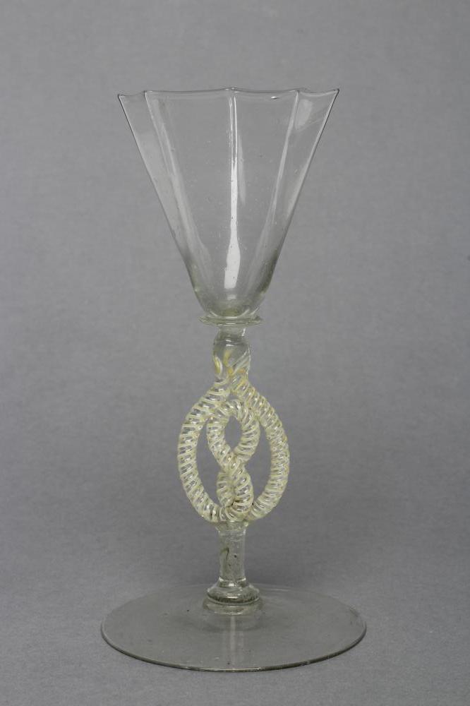 A FACON DE VENISE WINE GLASS, mid 17th century, the flared octagonal bowl on blade knopped