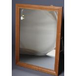 A COLIN ALMACK OAK FRAMED WALL MIRROR, the moulded oblong frame with carved beaver trademark in high