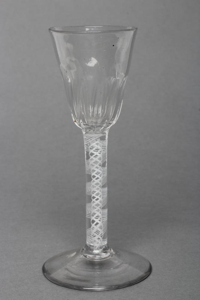 A WINE GLASS, mid 18th century, the semi-wrythen mould blown round funnel bowl on an opaque twist