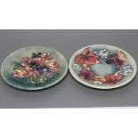 TWO MOORCROFT POTTERY PLATES, mid 20th century, both of plain circular form, tubelined and painted