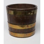 AN OAK AND BRASS BANDED JARDINIERE, 20th century, of circular coopered construction with tapering
