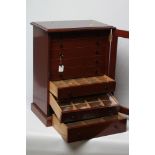 A MAHOGANY SPECIMEN CABINET, the glazed outer door enclosing eight drawers with turned knob handles,