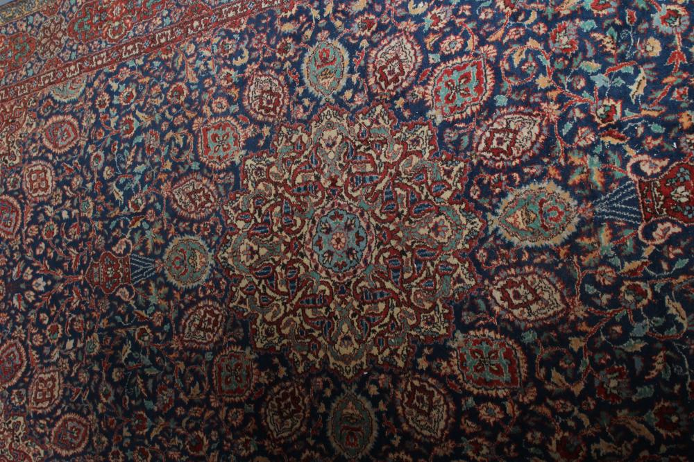 A PERSIAN RUG, the navy blue floral field centred by an ivory circular gul with matching - Image 3 of 4