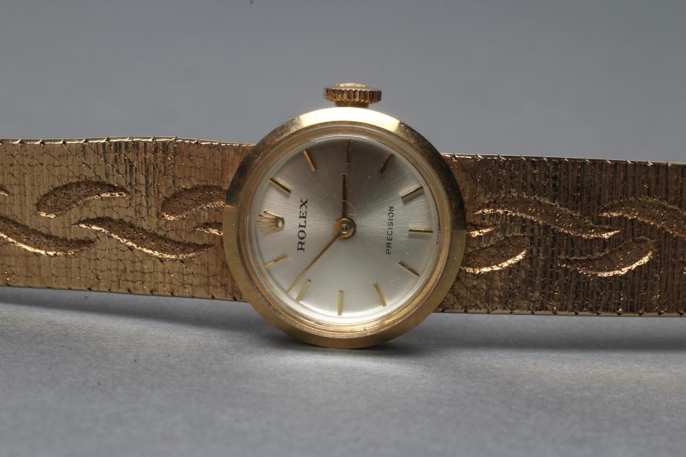 A LADY'S 9CT GOLD ROLEX WRISTWATCH, the champagne dial with gilt metal batons, the eight jewel