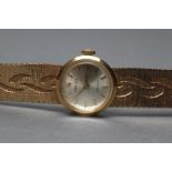 A LADY'S 9CT GOLD ROLEX WRISTWATCH, the champagne dial with gilt metal batons, the eight jewel