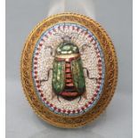 A VICTORIAN MICRO-MOSAIC OVAL BROOCH, the coloured and lustre tesserae worked as a scarab on a white