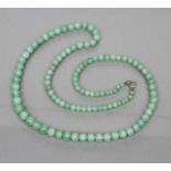 A STRING OF POLISHED GRADUATING JADE BEADS, 19" long (Est. plus 21% premium inc. VAT)