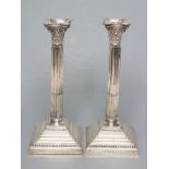 A COMPOSITE PAIR OF CORINTHIAN COLUMN CANDLESTICKS, maker Ellis & Co., Birmingham 1912 and 1915,