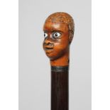 A GENTLEMAN'S WALKING STICK, early 19th century, the pommel carved as the head of a man with white