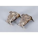 A PAIR OF EDWARDIAN NAPKIN RINGS, maker Liberty & Co., Glasgow 1911, of plain "D" form on dolphin