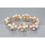 A MODERN CULTURED PEARL BRACELET, the seven abstract set panels of seven pearls wired to a plain