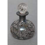 A CLEAR GLASS SCENT BOTTLE of squat globular form with wrythen cut stopper, the Sterling silver