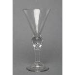 A WINE GLASS, mid 18th century, the conical bowl on inverted balustroid stem with tear drop, on high