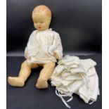 A vintage celluloid doll with unassociated doll's clothes. length 62cm.Condition ReportPlay worn.