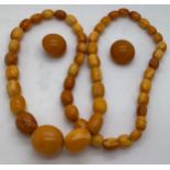 Graduated amber beads 66cms l and a pair of amber coloured clip on earrings. Total weight 58.4gm.