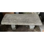 A concrete garden bench with rectangular top on a twin base decorated with grapes. 105cms w x