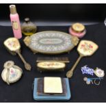A selection of embroidered gilt vanity sets to include mirror, brush, comb, hand brush, a lidded
