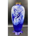 A Royal Doulton blue & white vase depicting a lady playing a guitar. Height 43 cm.Condition