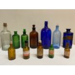 Twelve various chemist bottles, all coloured except one, to include poison bottles. Tallest 24cm