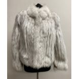 A silver fox fur jacket. Size 12. Approx 52cm from shoulder to hem.Condition ReportGood condition.