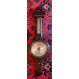 A well carved oak aneroid barometer. James Lucking & Co, Birmingham. 99cm h.Condition ReportSlight