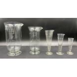 Set of five apothecary glass measuring cylinders: 2pt, 1pt, 2oz, 1oz and 1/2 oz. Provenance: Bratley