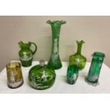 Seven pieces of 19thC green glass (one brown) with Mary Gregory decoration. Tallest vase 30 cm,