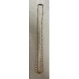 A single strand pearl necklace with 9ct white gold clasp and clear stone to centre. 51cm l.Condition