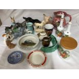 A selection of ceramics to includes Beswick donkey, Peter Rabbit and long haired dog, a Wade dog,