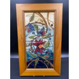 A Moorcroft "Hartgring" pattern plaque, depicting flowers and insects in pine surround.