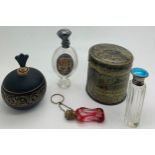 Perfume bottles etc to include a 19thC cranberry glass bottle with finger ring and chain, bottle