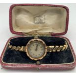 A 9 carat gold cased ladies wristwatch in contemporary fitted case. Total weight 21.5gm. Not