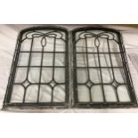 A pair of leaded glass window panels with arch top, clear glass with light blue glass border. 72 h x