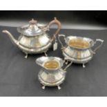 A silver three piece silver tea service Sheffield 1917 Albert Henry Thompson. Total weight 1093gm.