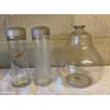 A glass carboy and two storage jars with push on metal lids. Provenance: Bratley Chemist,