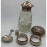 Silver and white metal to include glass and silver topped sugar shaker, 2 silver napkin rings,