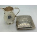 A silver cigarette case with foliate scroll engraving. Birmingham 1915 together with a silver jug