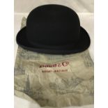 A Dunn & Co black bowler hat size 7 1/4 with retail paper bag.Condition ReportVery good condition.