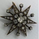 Yellow and white metal mounted diamond star brooch. Total weight 4.8gm. 3cm diameter.